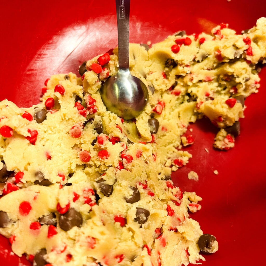 Chocolate cherry chip cookie dough in a red mixing bowl.