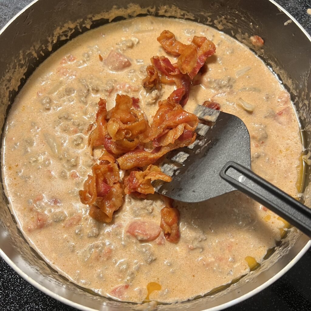 Adding bacon to cheeseburger soup.