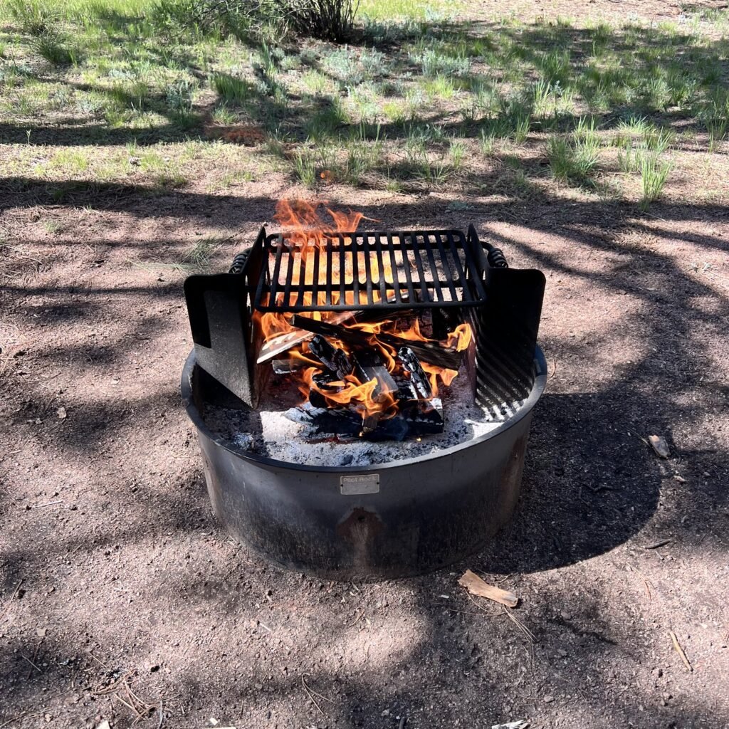 Picture of a campfire, getting the coals nice and hot for cooking a campfire breakfast.