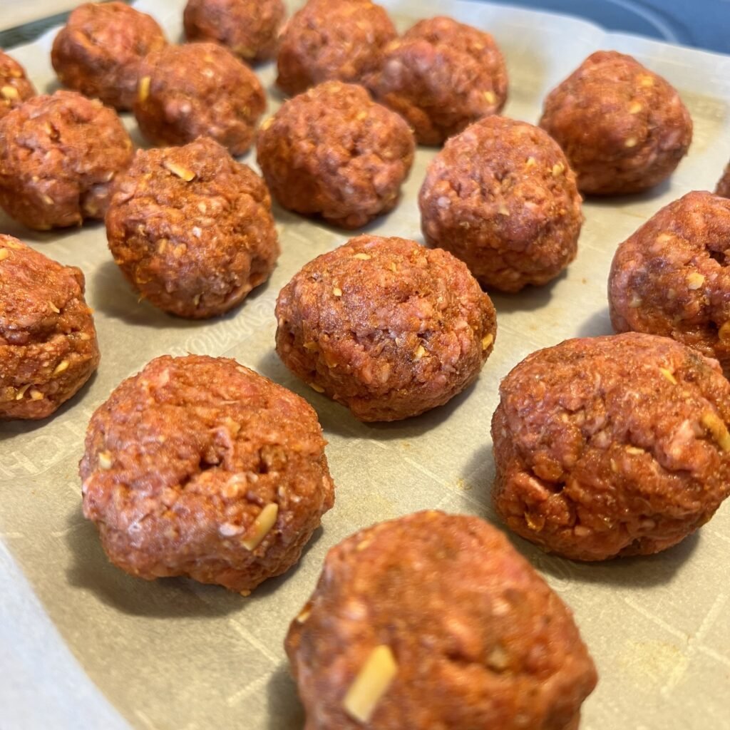 Prepared enchilada meatballs ready to go into the oven.