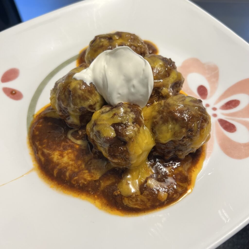 A family-friendly, hearty, and tasty keto dish. Enchilada Meatball Bake.