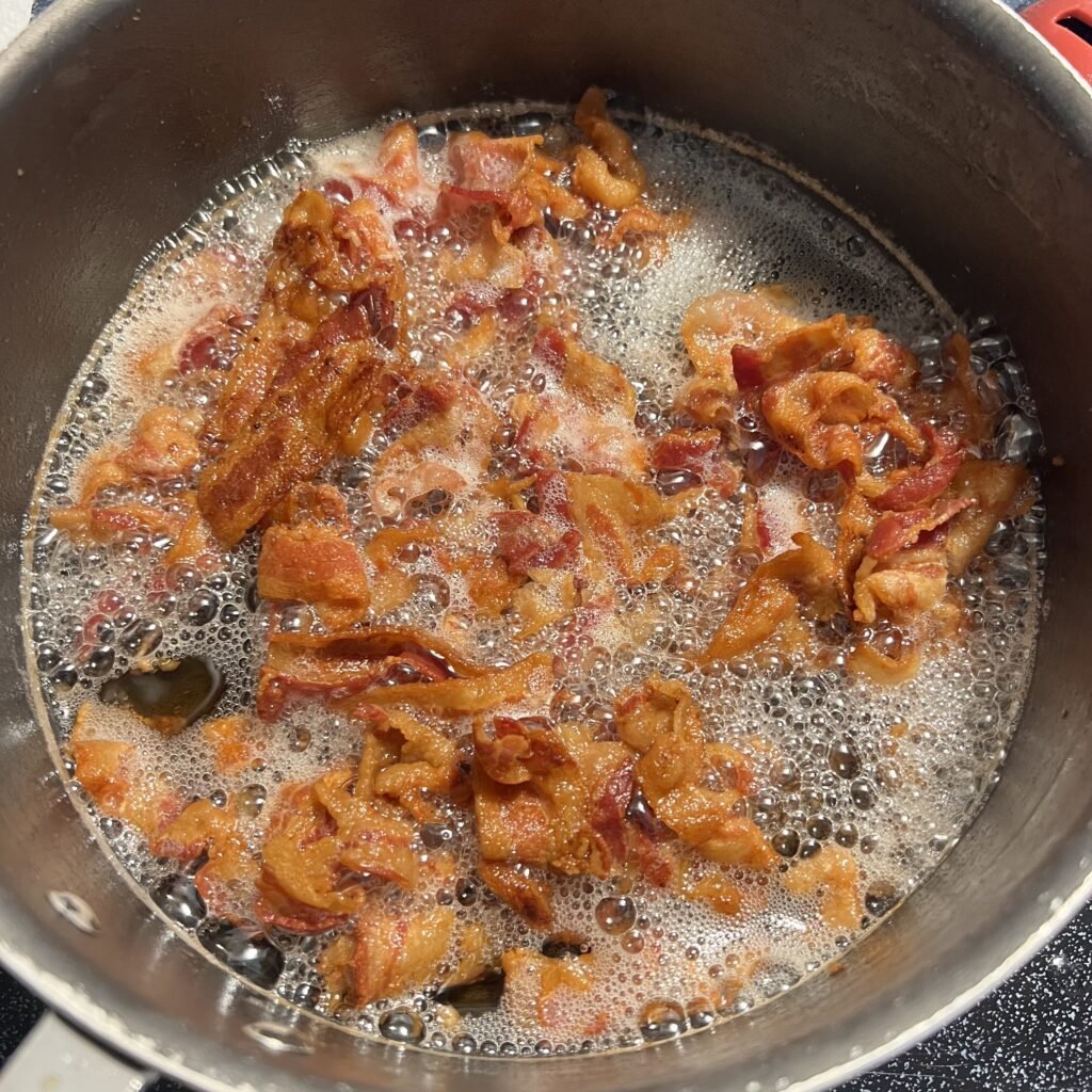 Frying bacon in a saucepan.