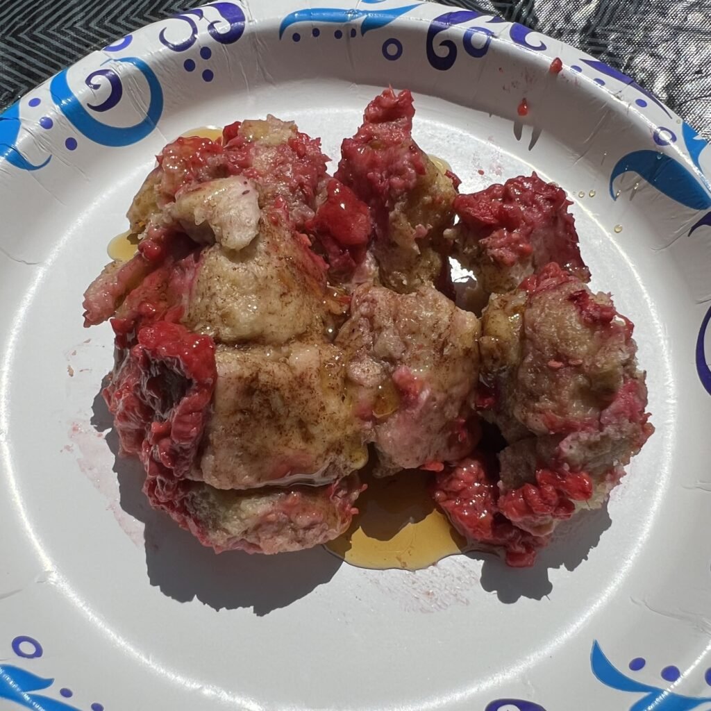Campfire french toast served with maple syrup.