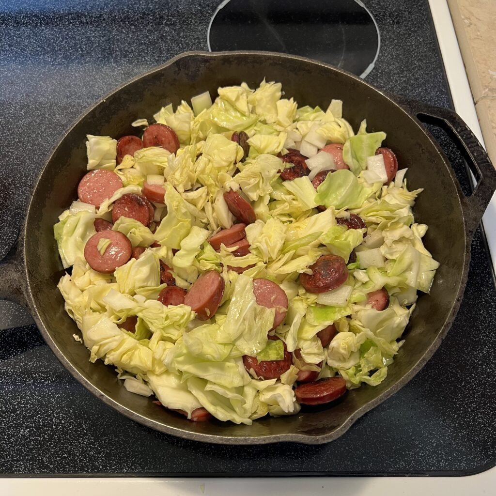 Preparing a sausage and cabbage skillet.