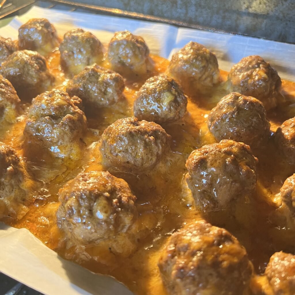 Yummy enchilada meatballs baking in the oven.