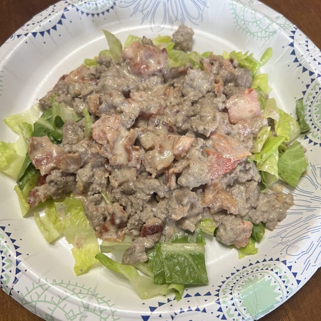 Cream BLT ground beef skillet served over a bead of fresh romaine lettuce.
