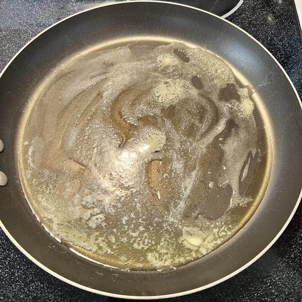 Melting and heating up delicious butter to prepare to make an easy keto skillet meal.