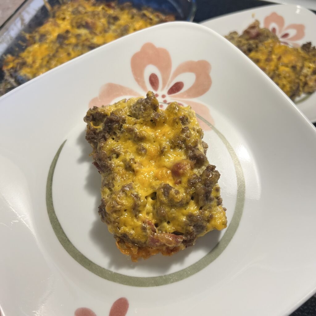 A plate of cheesy carnivore casserole fresh out of the oven.