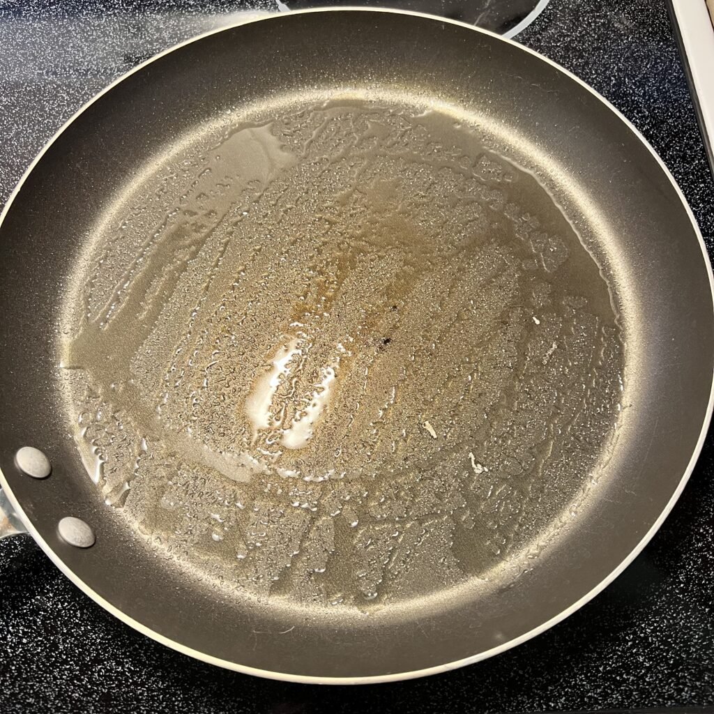 A greased frying pan ready to make delicious and fluffy sourdough pancakes