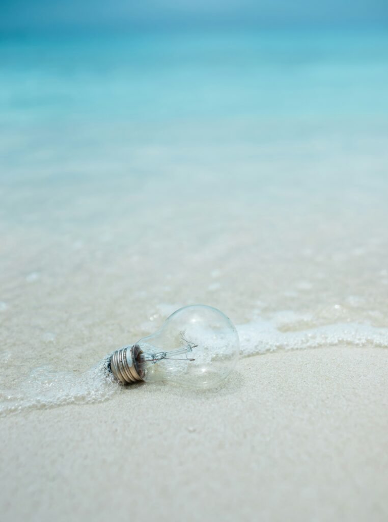A light bulb washed up to the shore on the beach.