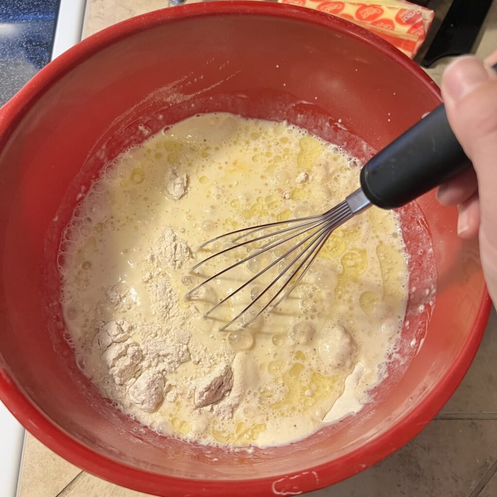 Whisking sourdough discard pancake batter.