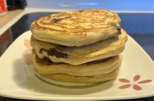 A stack of fluffy sourdough discard pancakes with rich Ghirardelli chocolate chips