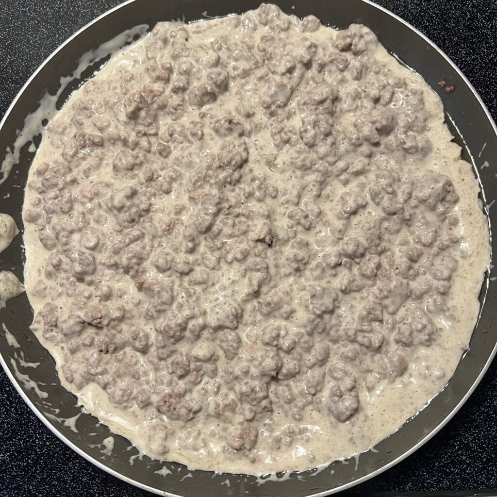 Overhead shot of creamy Alfredo ground beef in a frying pan on the stove. This 2-ingredient meal is perfect for busy weeknights.