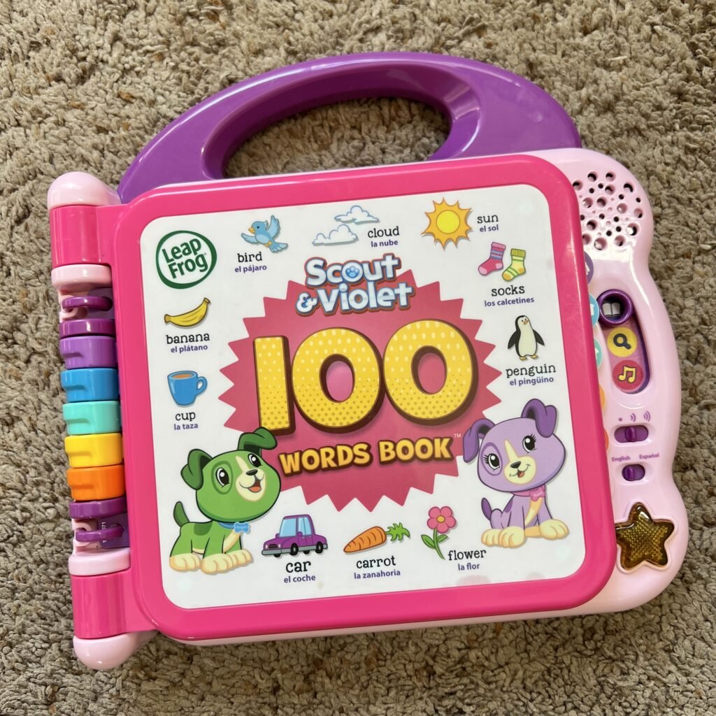 An overhead picture of the Leap Frog Scout and Violet 100 Words Book. An interactive learning book for one-year-olds.