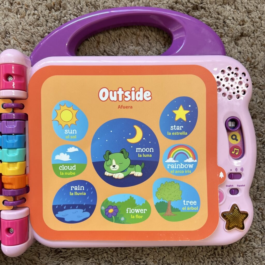 A close-up of the Outside page of the interactive Leap Frog learning book, titles Scout & Violet 100 Words Book.