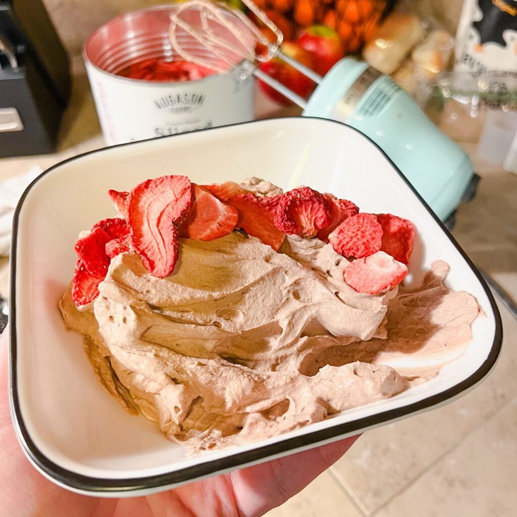 A delicious bowl of clean chocolate mousse served with freeze dried strawberries. A delicious, clean, and family-friendly dessert!