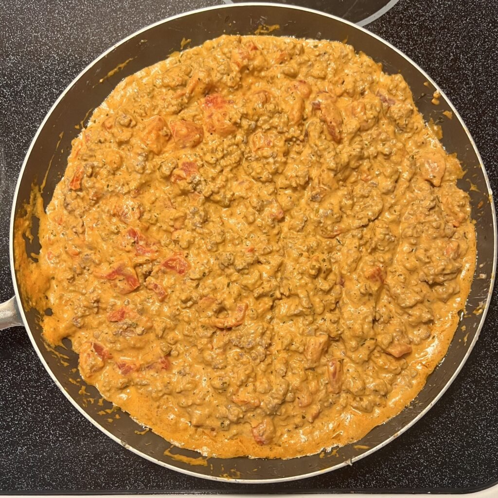 A fully mixed and cooked creamy tomato and marinara ground beef skillet.