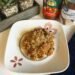 An overhead shot of a plate of creamy ground beef with tomatoes and marinara. Served with grated parmesan cheese for a simple and hearty family dinner.