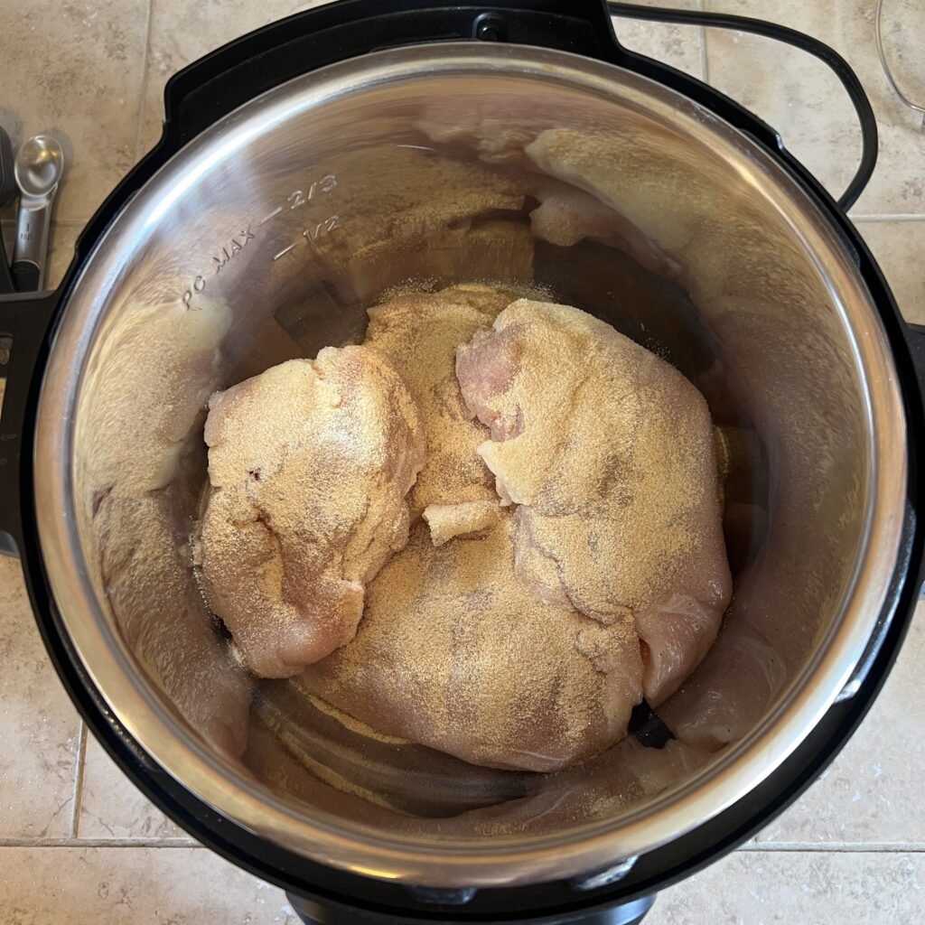 Seasoned chicken breasts in an instant pot. Just add broth and they're ready to pressure cook.