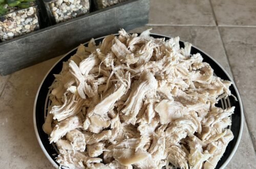 A plate of freshly cooked and shredded chicken breasts. These were pressure cooked in the instant pot for quick and easy food prep.