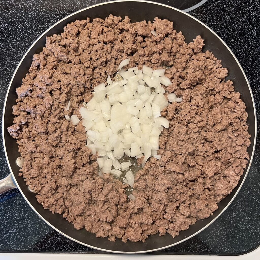 An overhead shot of browned ground beef and onions.