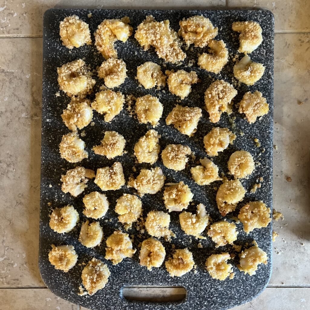 An overhead shot of Porq Panko covered shrimp ready to be refrigerated before frying.
