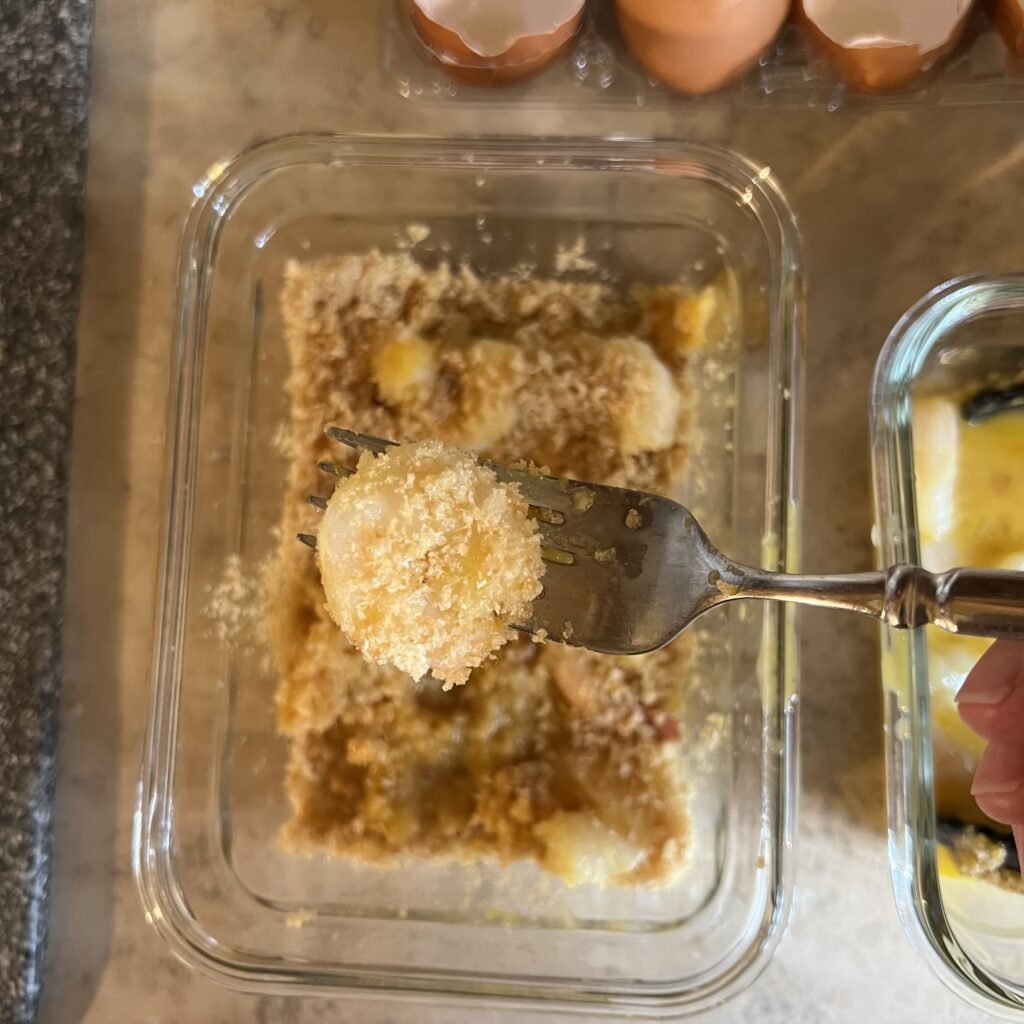A picture of a piece of Porq Panko "breaded" shrimp on a fork.