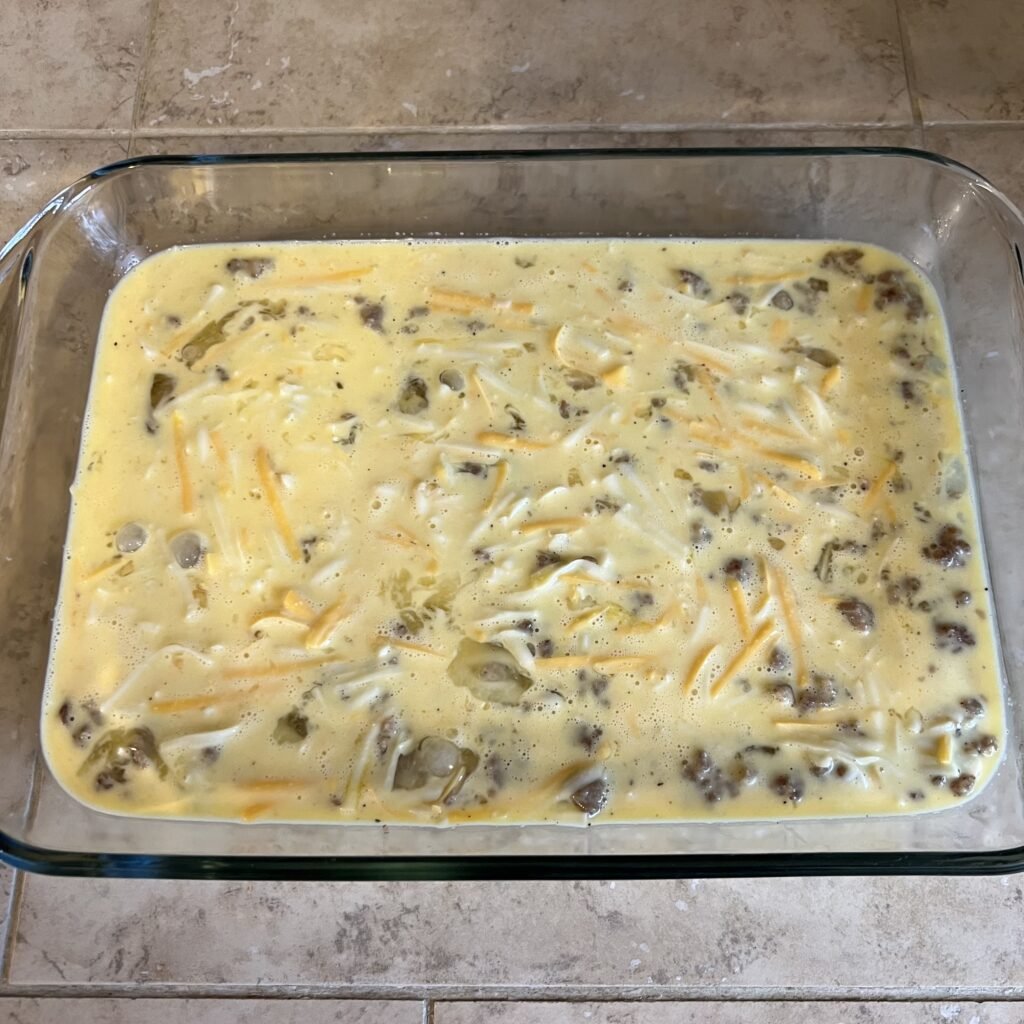 An overhead shot of a Keto Sausage & Egg Breakfast Casserole right before it goes into the oven to bake.