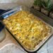 A side shot of a freshly baked keto breakfast casserole on the count with a blue towel and succulent plants in the background.