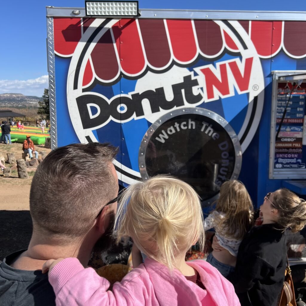 Getting fried donuts at the pumpkin patch. A fun family tradition.