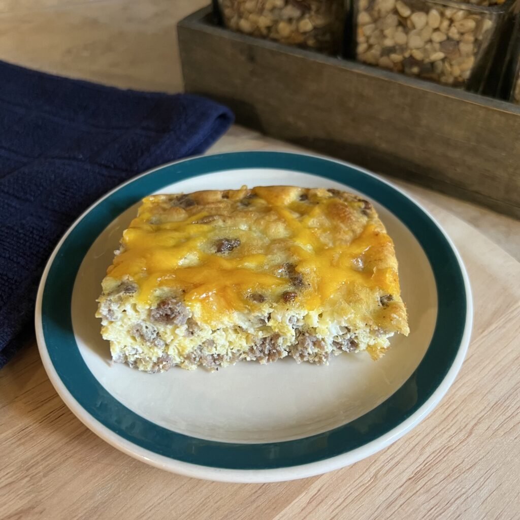 A single serving of keto breakfast casserole served on a small plate. A delicious and hearty breakfast.