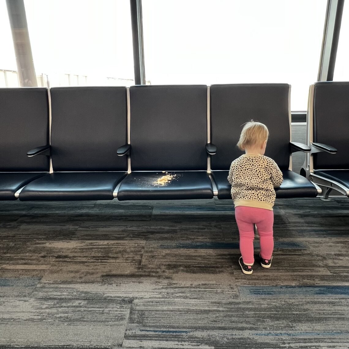 In the Colorado Springs airport with a toddler, making messes, and waiting to board the plane.