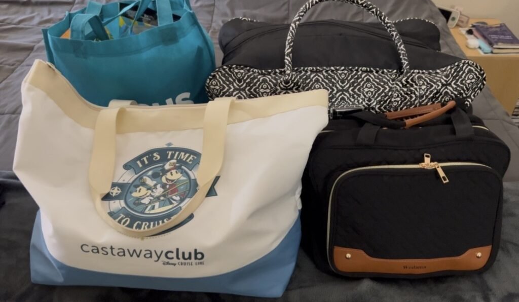 A picture of packed luggage ready for a family's 1-night stay at the Great Wolf Lodge. Also pictured, a Disney Castaway Club bag that is perfect for other family adventures beyond Disney.
