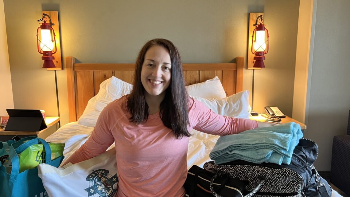 A mom with all of her family's packed bags sharing a free Great Wolf Lodge Packing List.