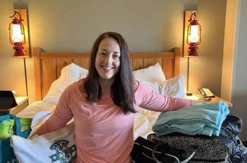 A mom with all of her family's packed bags sharing a free Great Wolf Lodge Packing List.