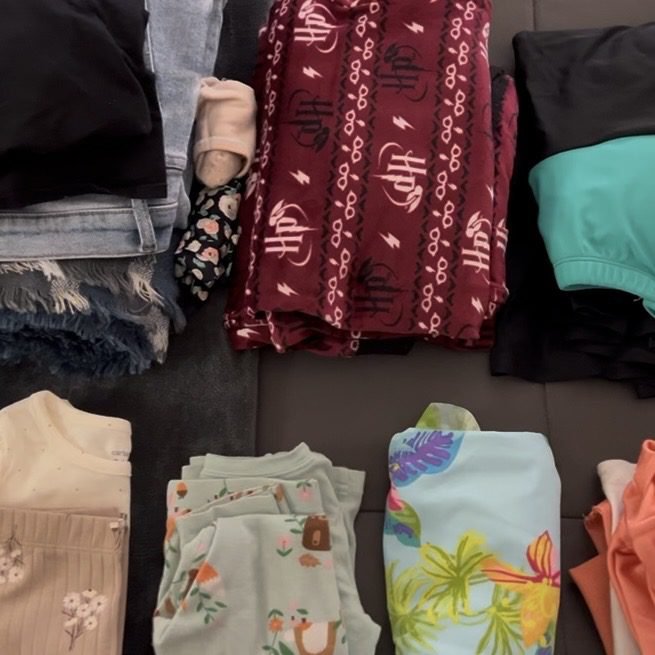 Clothes laid out to be packed. Get you FREE Great Wolf Lodge Packing List!